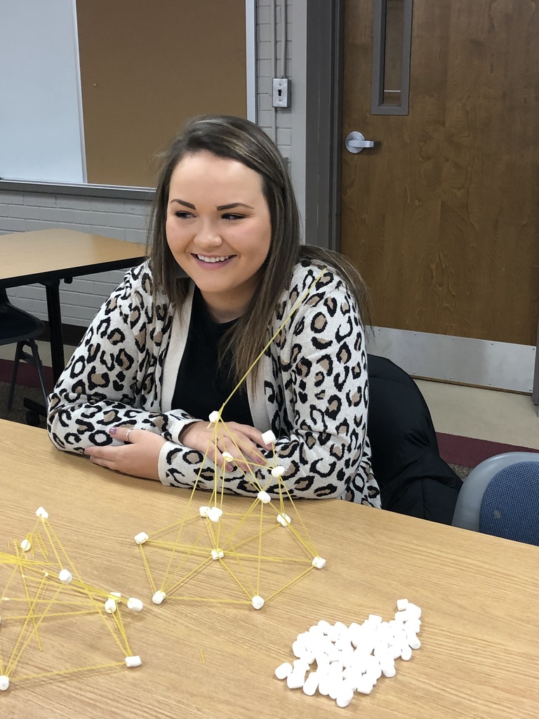 Teacher building with spaghetti and marshmallows