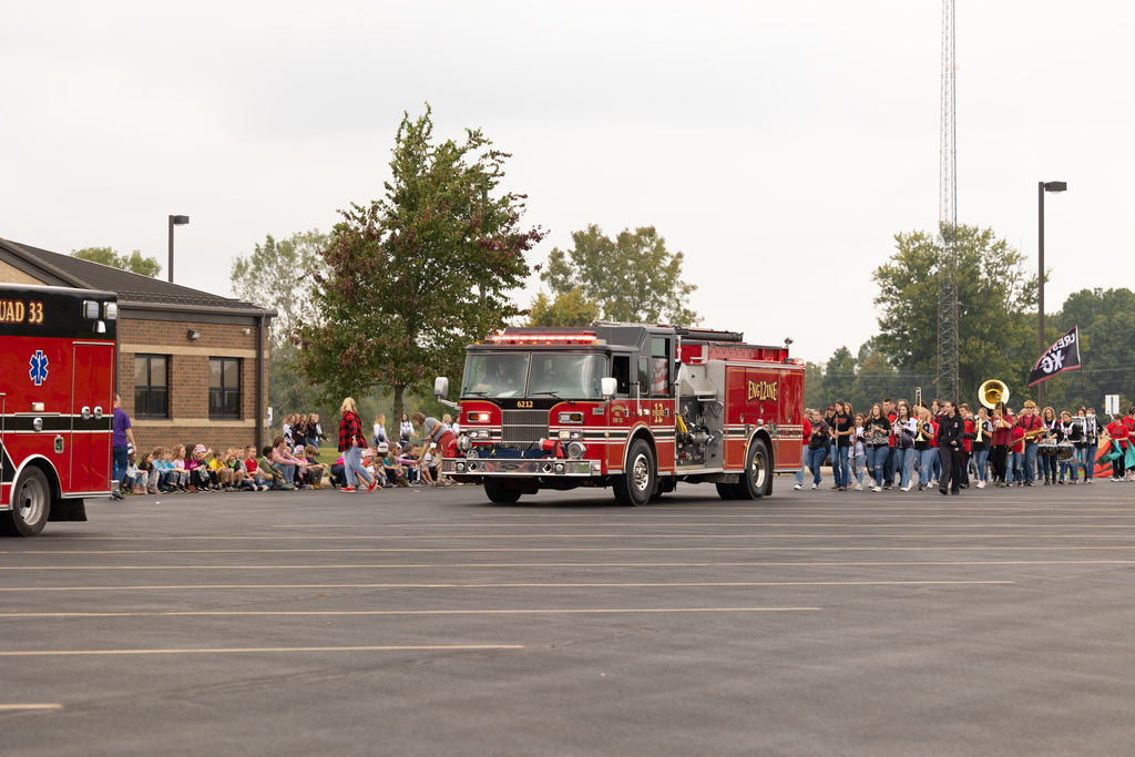 Emergency responders followed by high school students