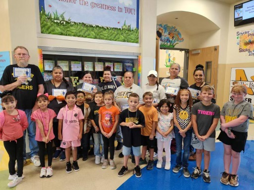 students posing with custodian