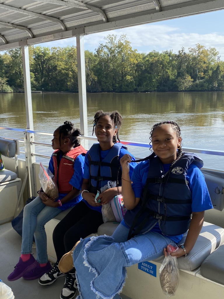 Fourth graders smile while cruising down the James River.