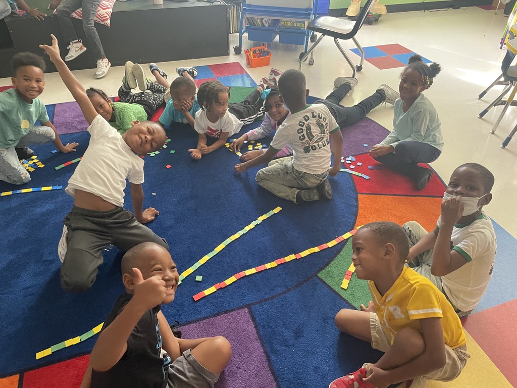 A class of kindergarten students share their patterns with each other.