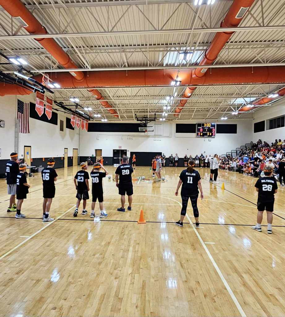 A dodgeball tournament takes place in a school gym.