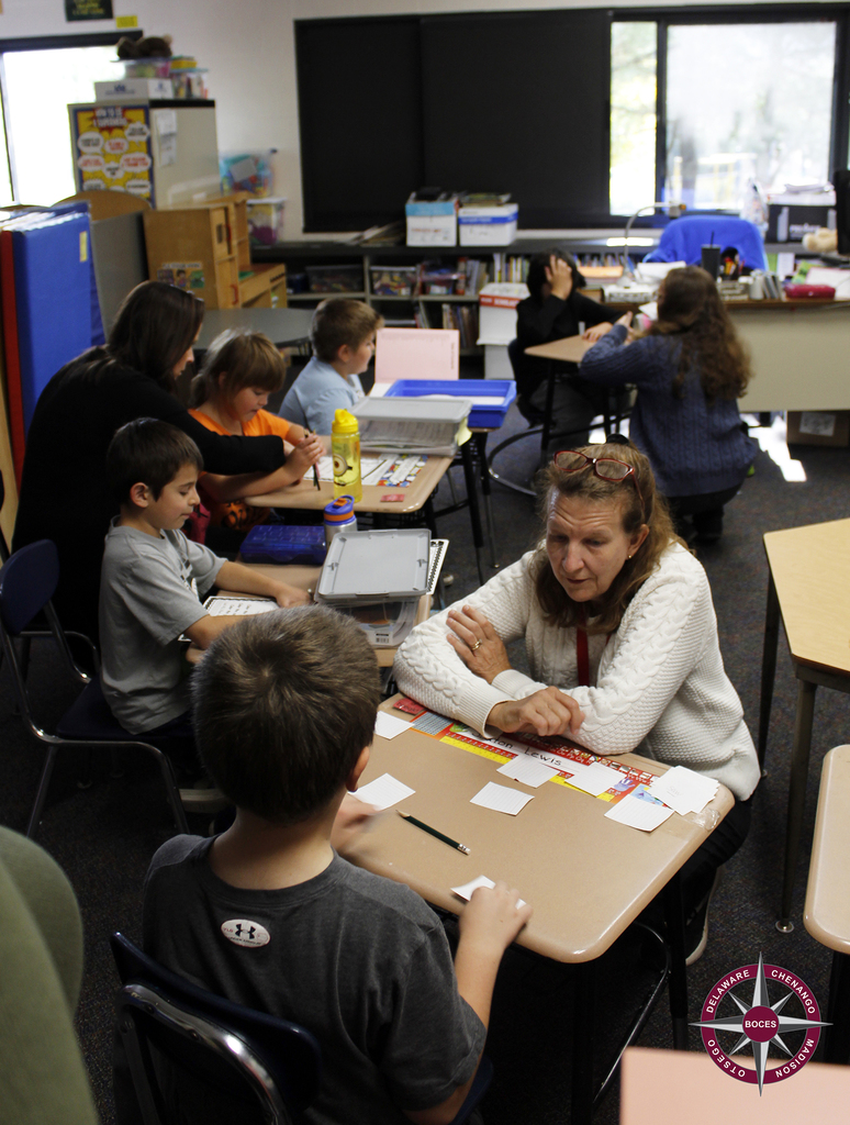 Ms Acunto works with students in their new classroom