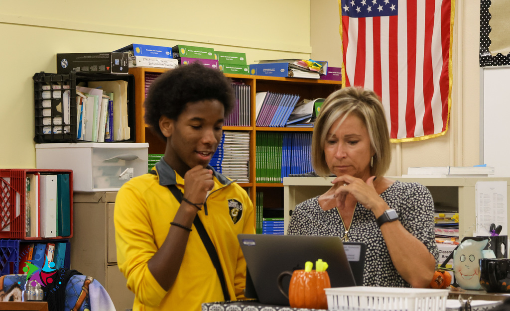 Student working with teacher