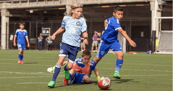 Three boys playing soccer