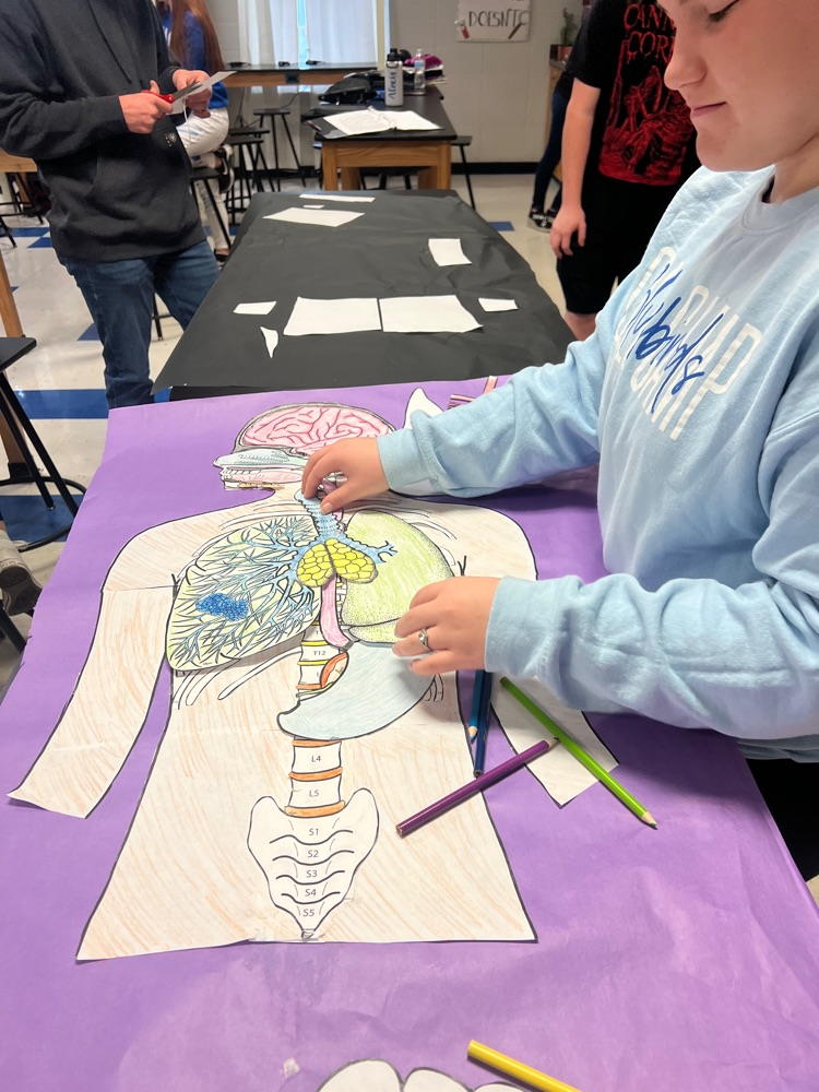 students working on piecing their project together
