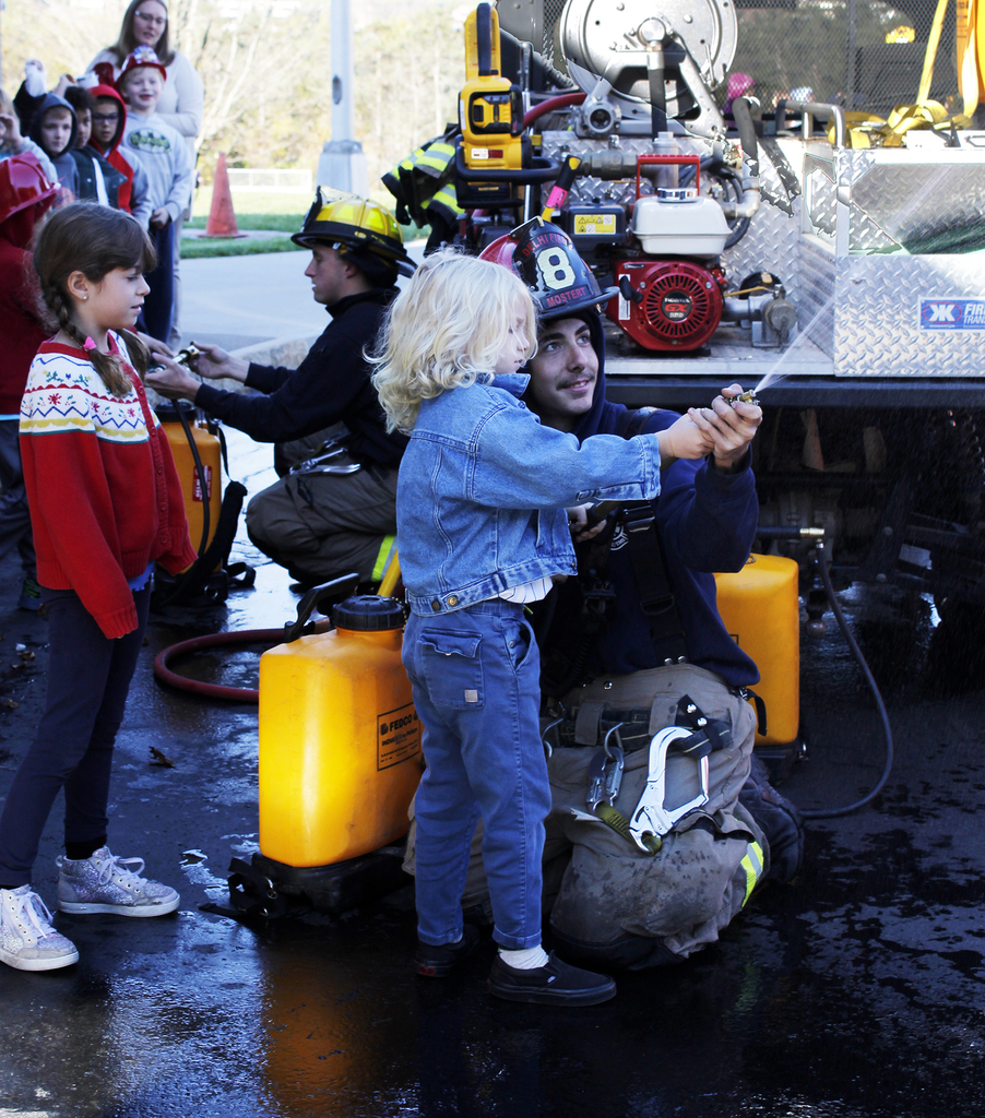 elementary students with volunteer firefighters