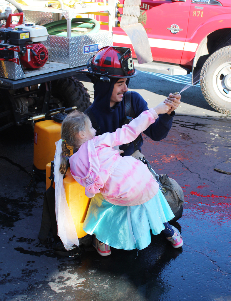 elementary student with volunteer firefighter