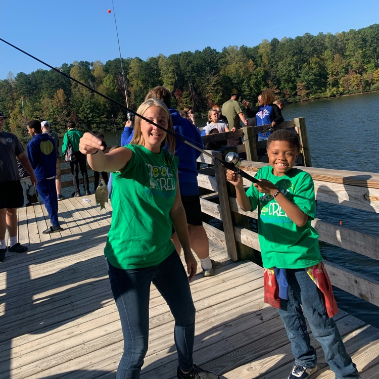 student caught a fish with teacher 