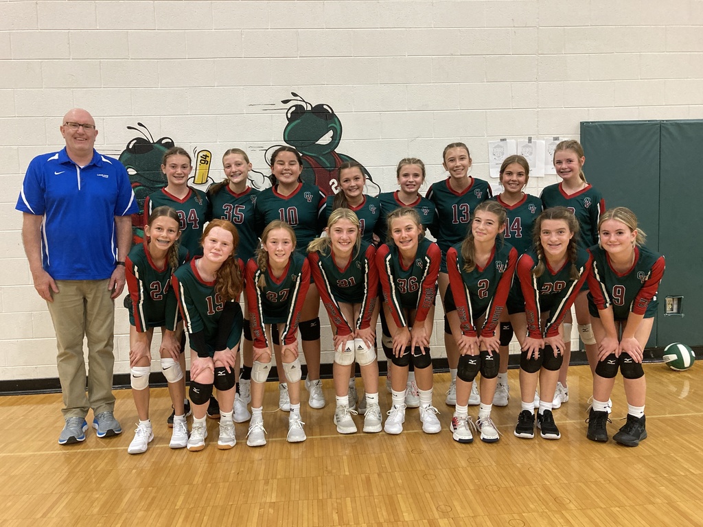 7th grade girls volleyball team posing as a group