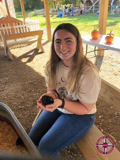 student holds a small animal