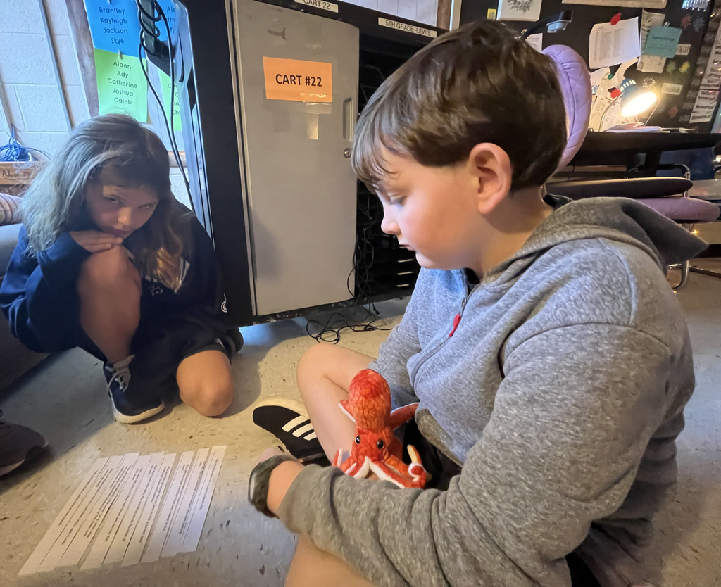Two students work on an English assignment about sequencing.
