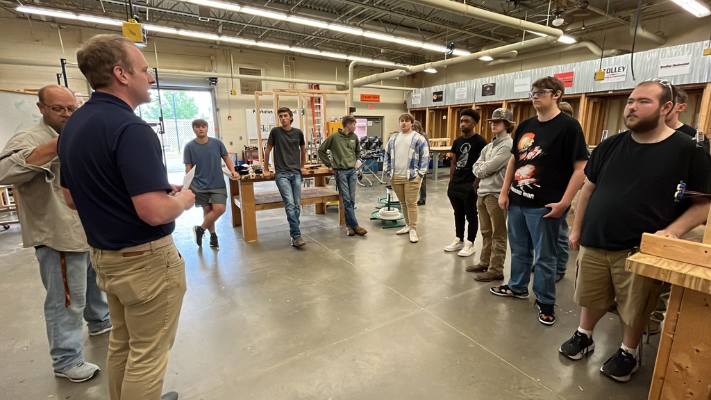 A man speaks to a group of students.