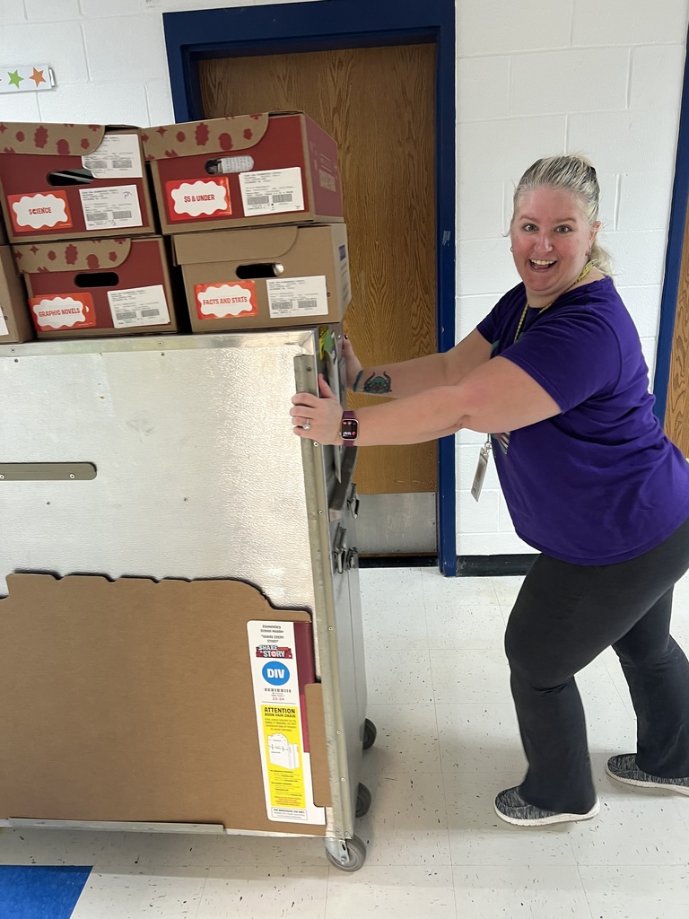 Mrs Chesworth pushing a book fair cart