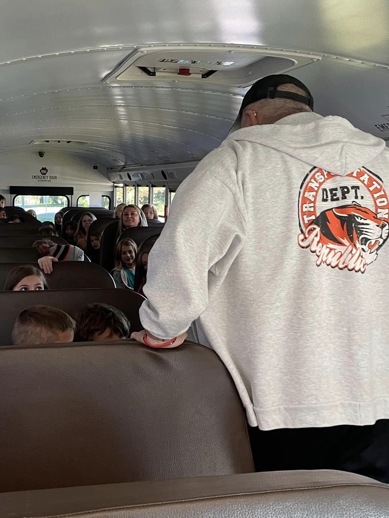 Students listening to bus driver