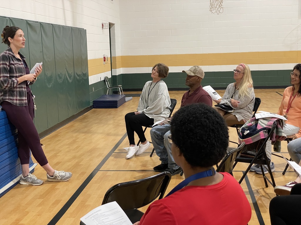 group leader giving a presentation to a small group of people