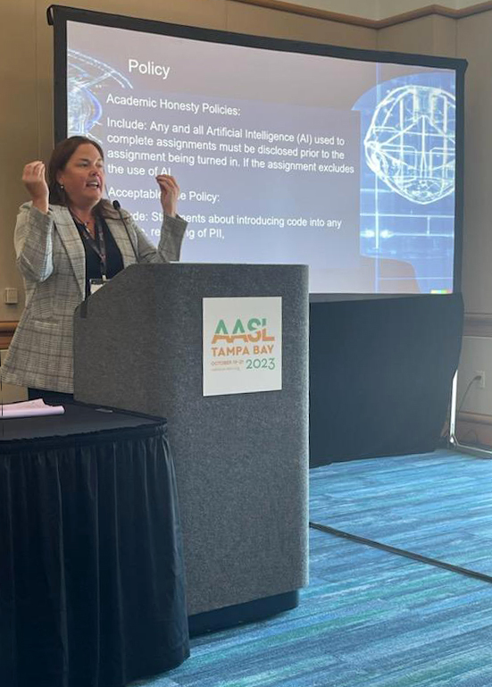 Betsy Hartnett speaking at conference