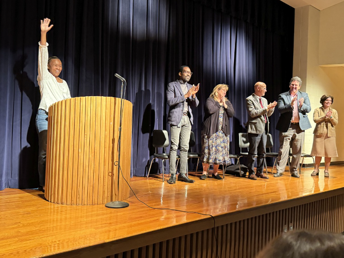 Teacher accepting award on stage