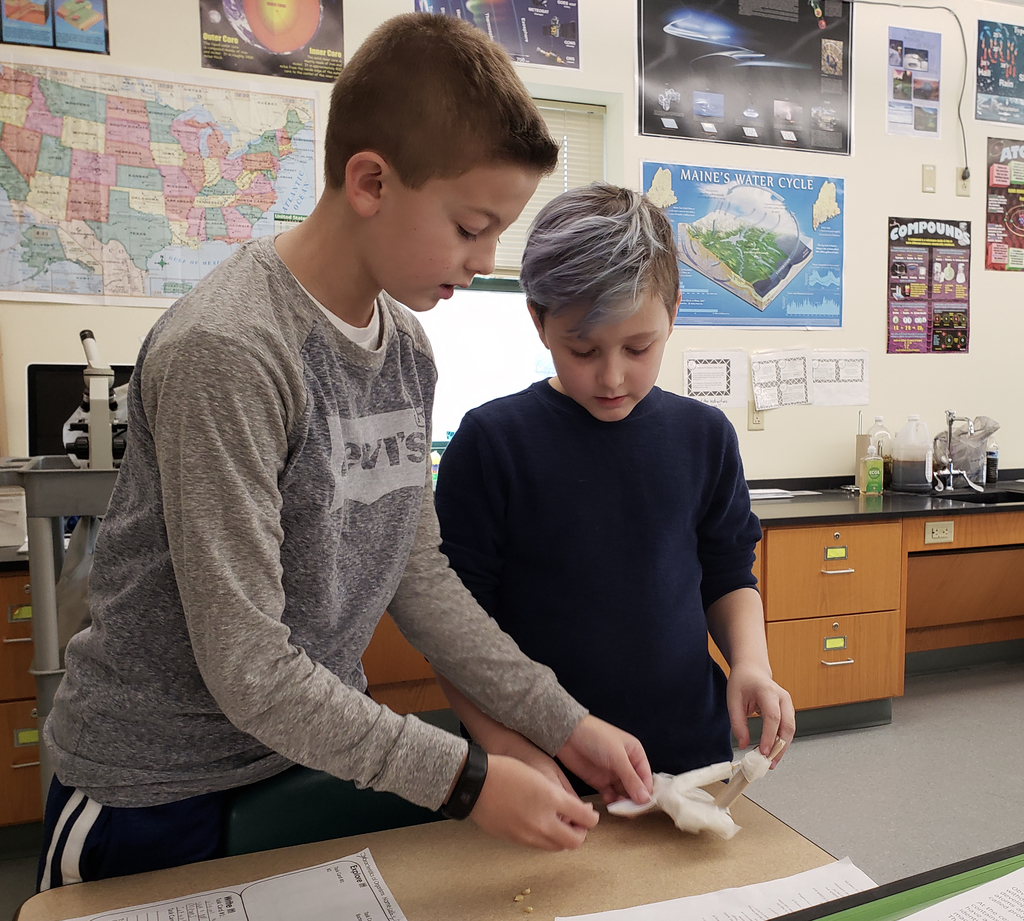 Two students making a catapault
