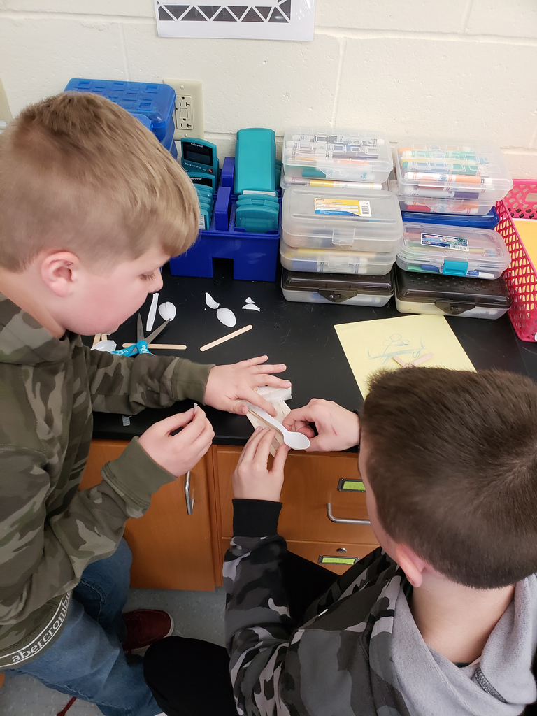 Two students testing a catapault