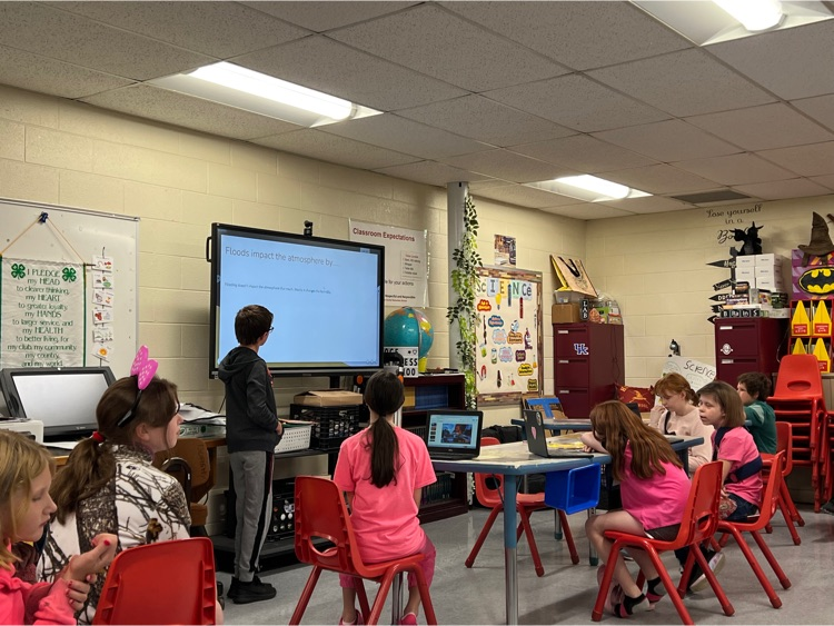 5th grade science students practicing for demonstration day. Students are presenting research about environmental disasters and their impacts on the world around them.