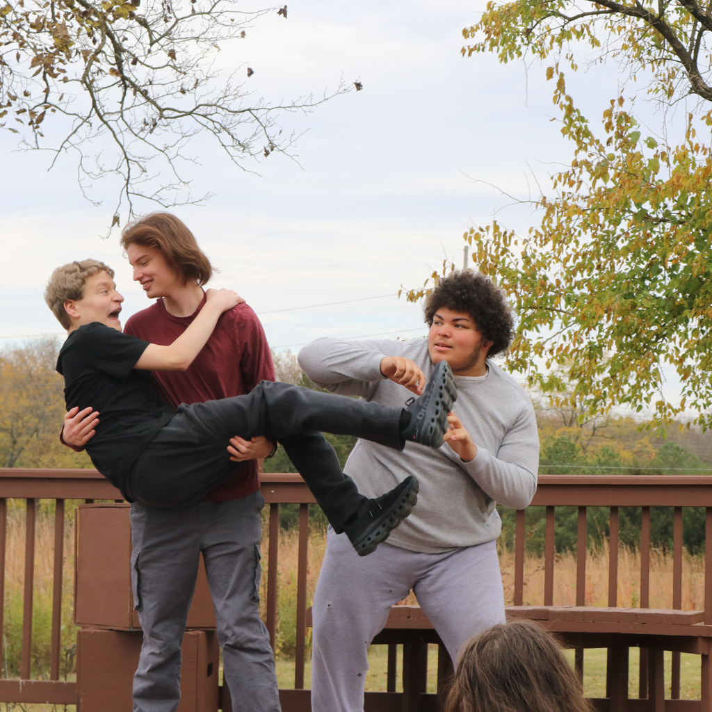 Three cast members rehearse a scene from the fall play.