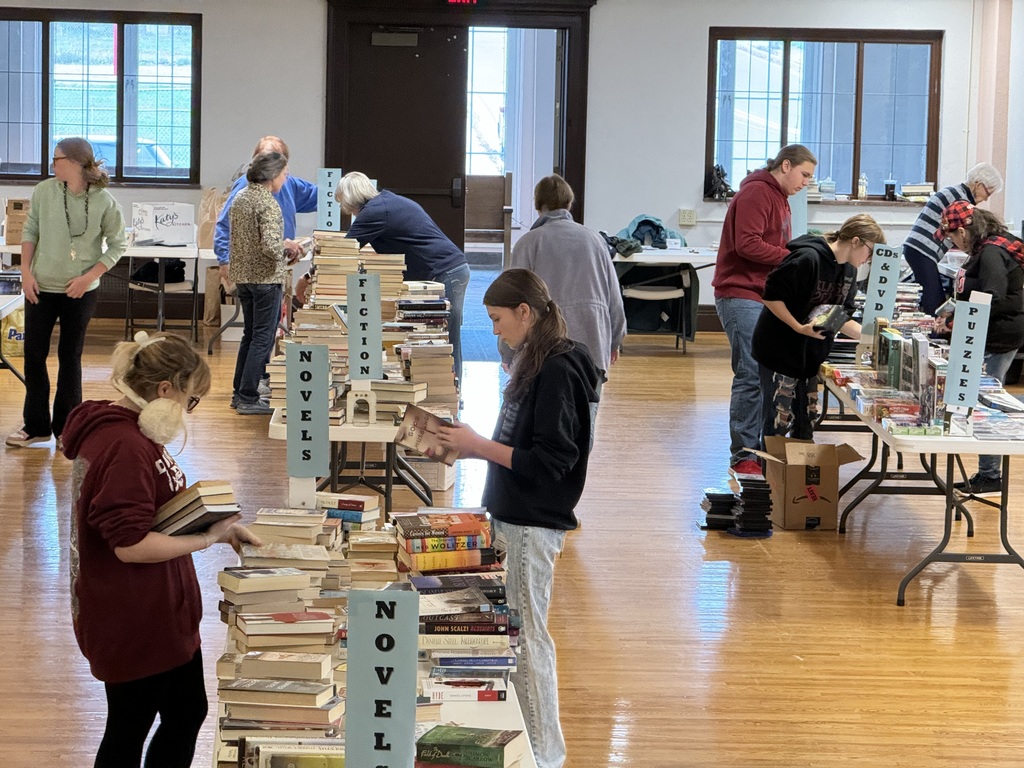 Students and adults moving books