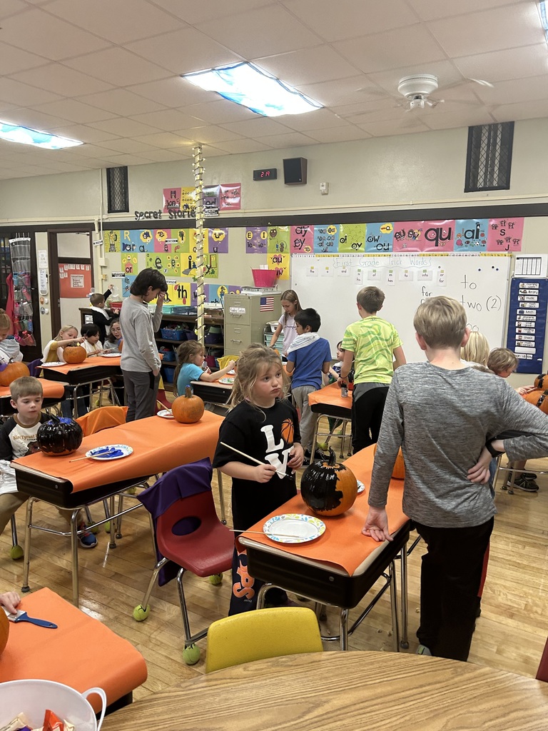 Students painting pumpkins