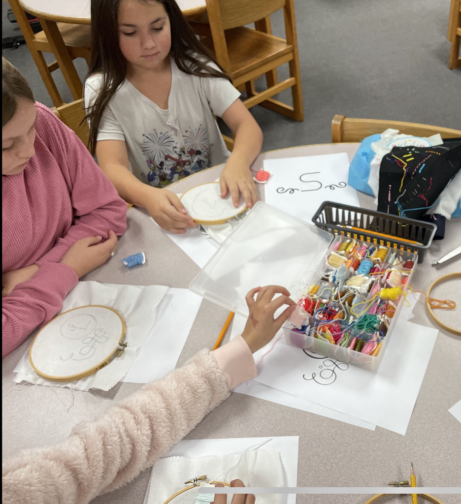Students practice sewing.