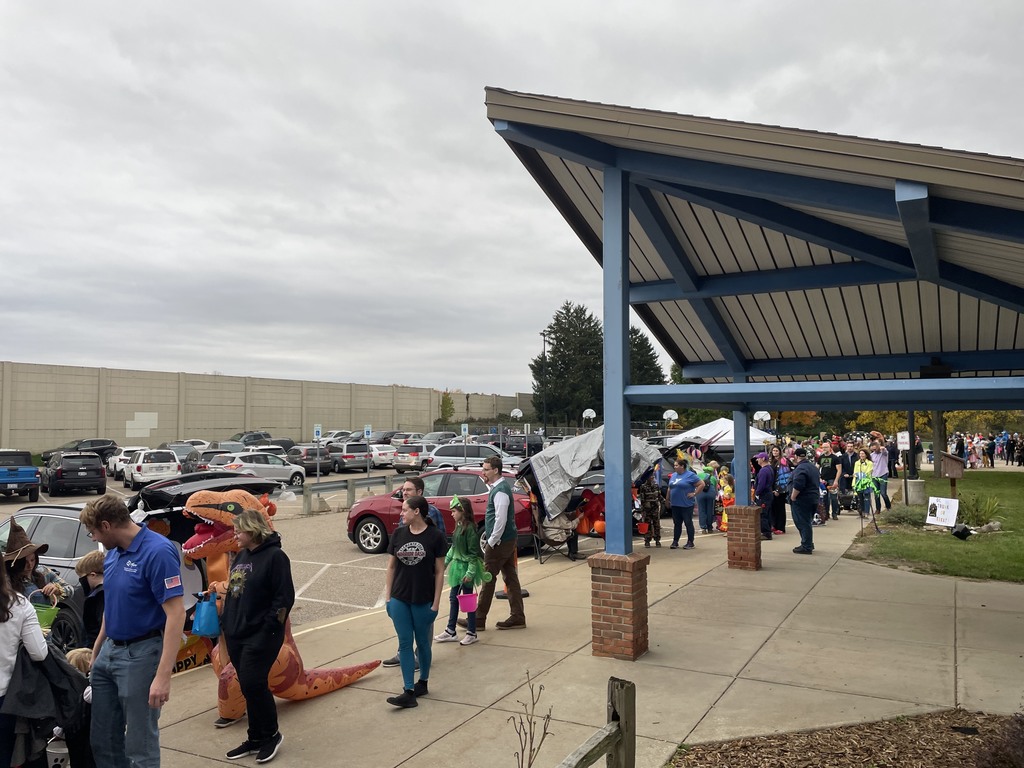 people in costumes outside a school