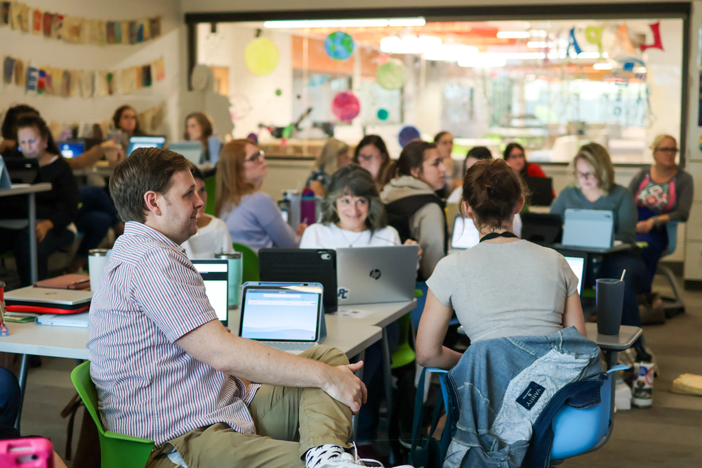 people at a desk in classroom