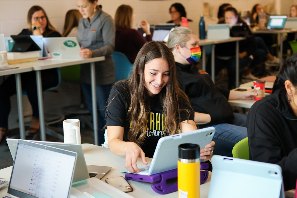 people at a desk in classroom