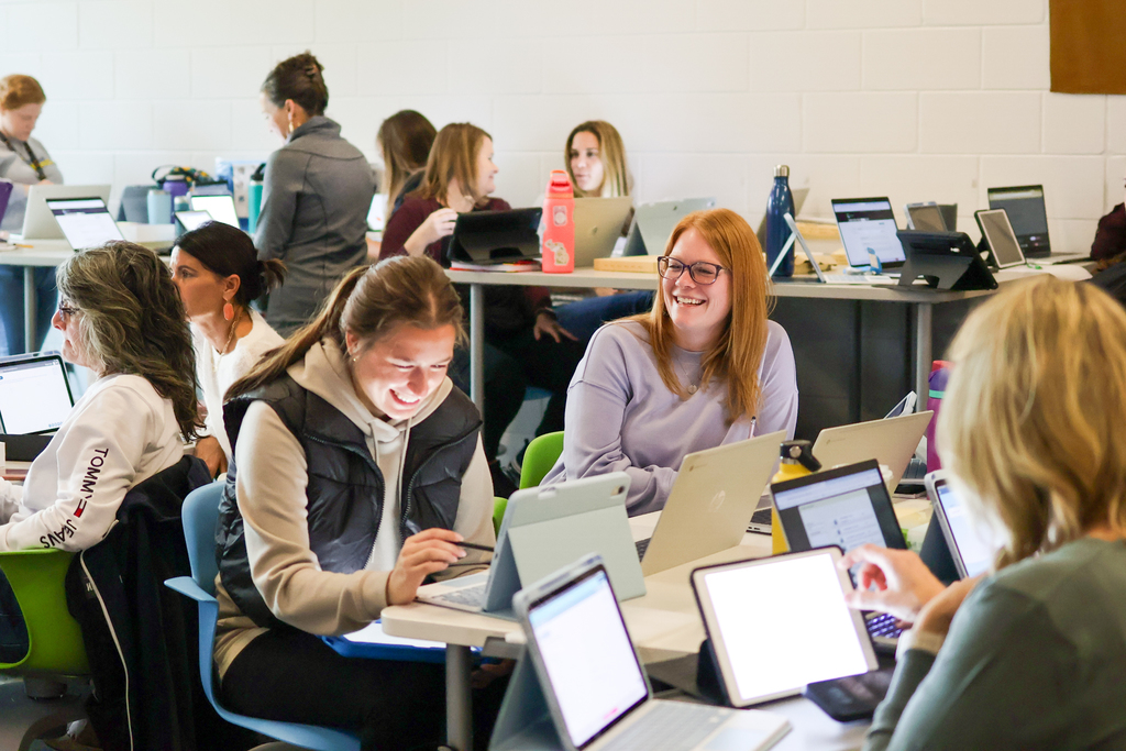 people at a desk in classroom