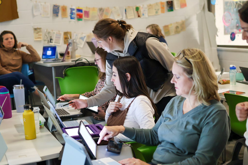 people at a desk in classroom