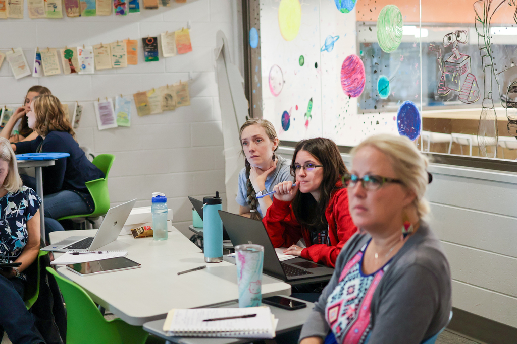 people at a desk in classroom