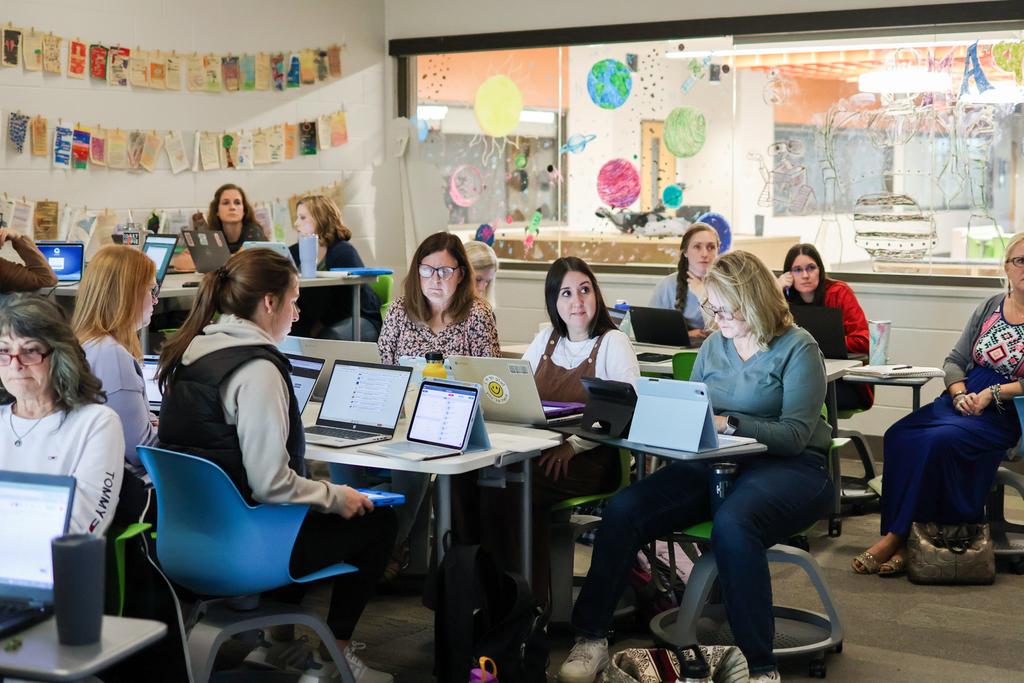 people at a desk in classroom