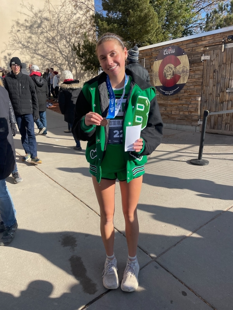 Quincy Bowling holding medal for State Cross Country