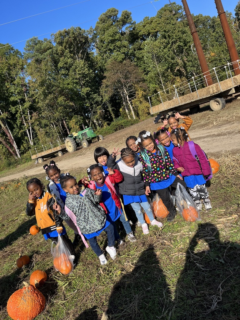 PK class stands with their pumpkins.