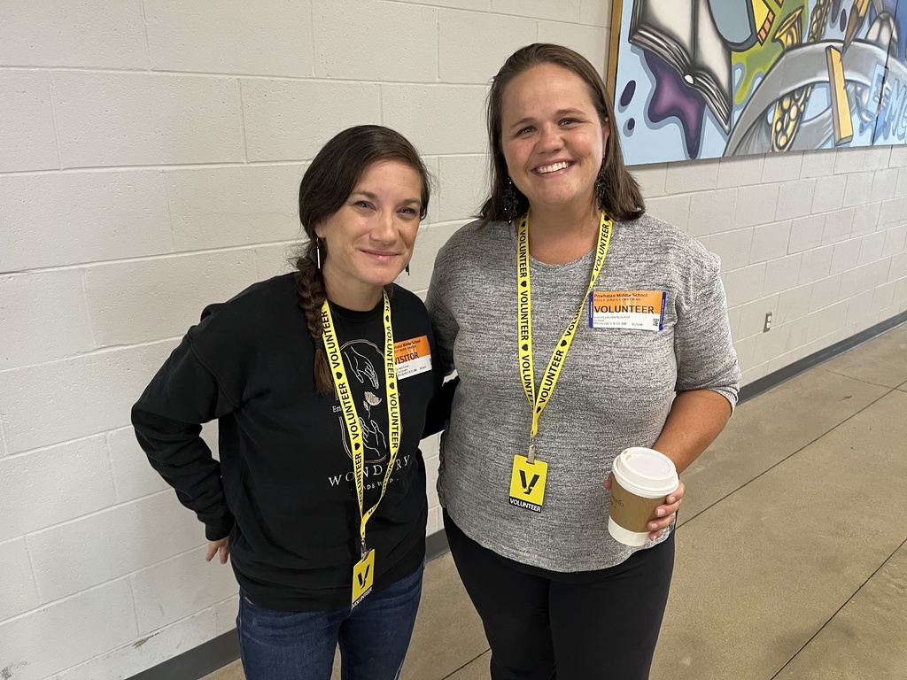 Two women smile at the camera.