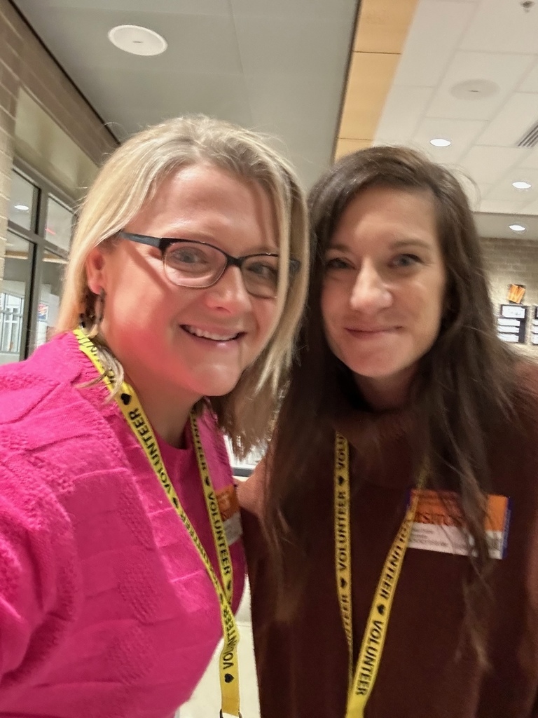 Two women smile at the camera.