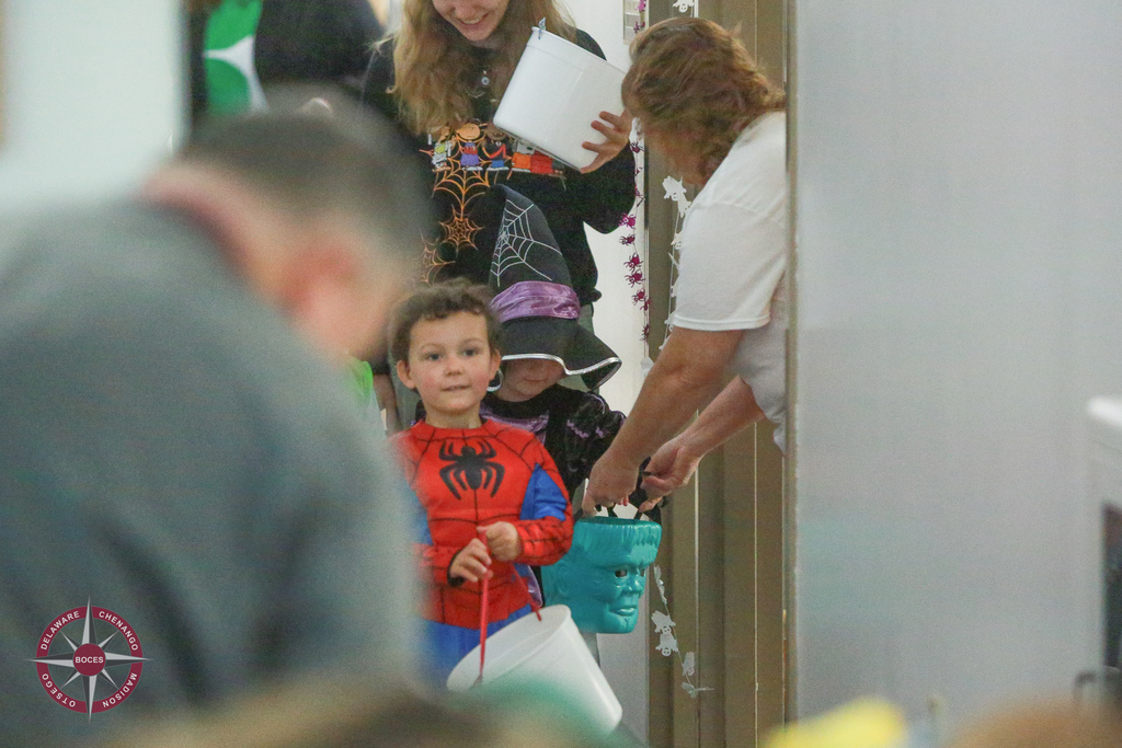 children in costume receive treats