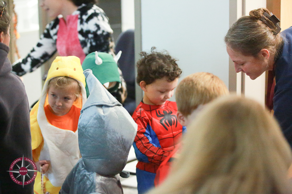 children in costume receive treats