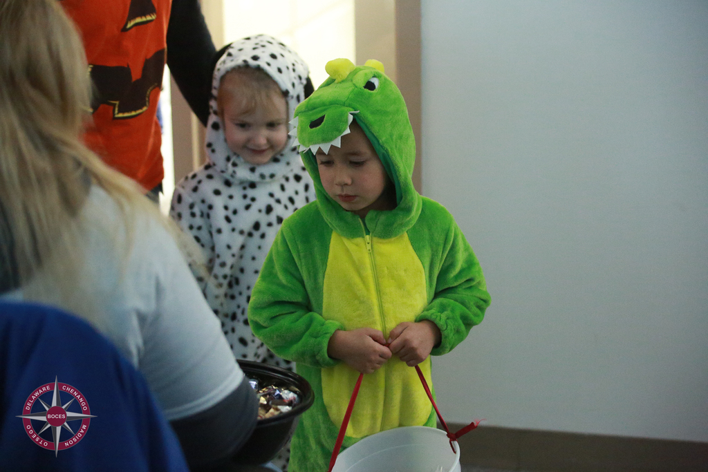 children in costume receive treats