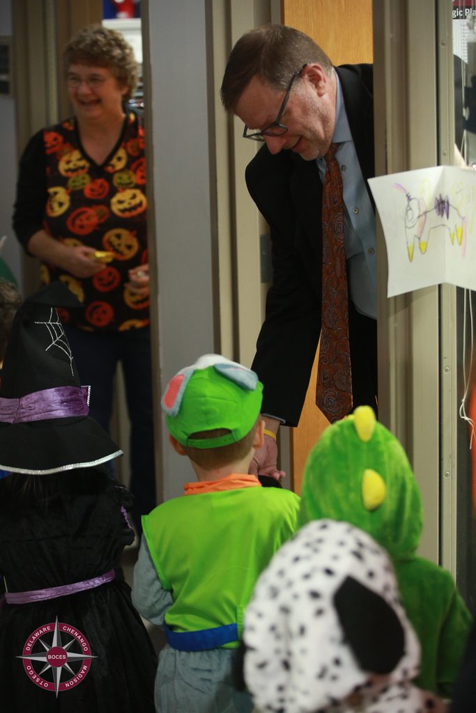 children in costume vist workers