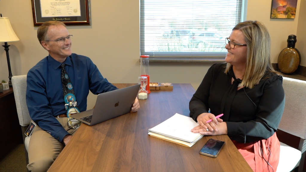 Dr. Mike Slagle seated at a table with Dr. Glenna Bult