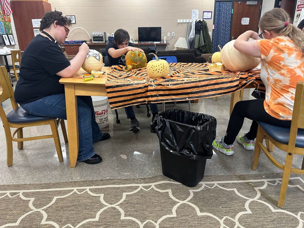 students carving pumpkins