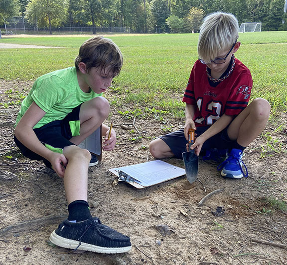 Students learn about soil during STEM Day.