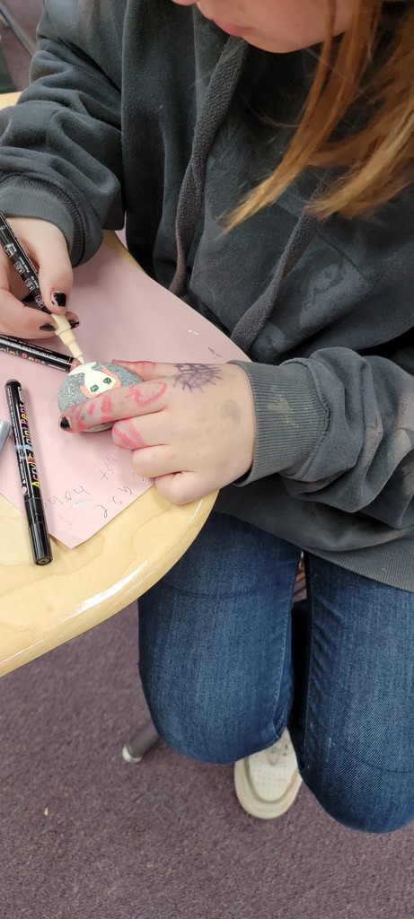 Student painting rock