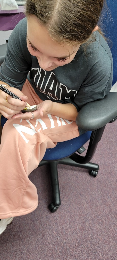 Student painting rock