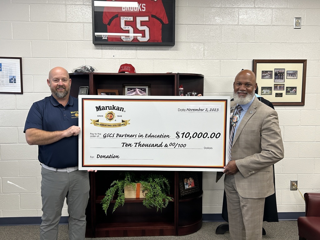 2 men holding a big check